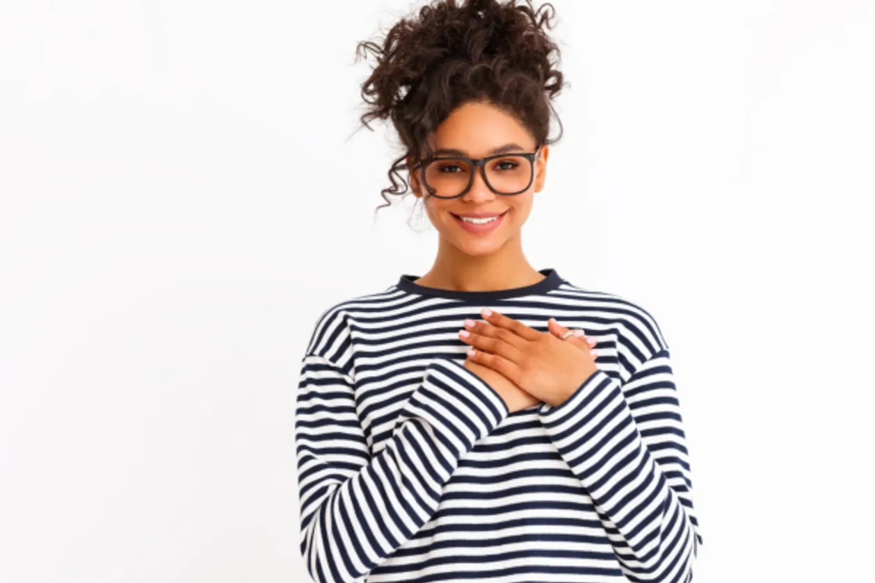 ethnic woman showing gratitude with hands on chest